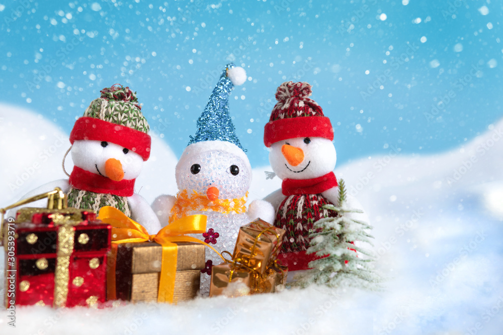 Snowman in a snowdrift with gifts for Christmas and New year Snowman in a snowdrift with gifts for Christmas and New year