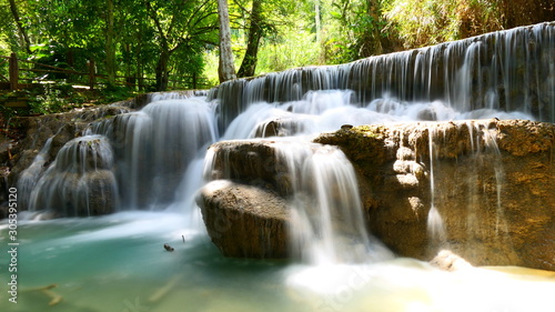 A beautiful rock formation with a small lake within the Kuang Si Falls in Luang Prabang, Laos