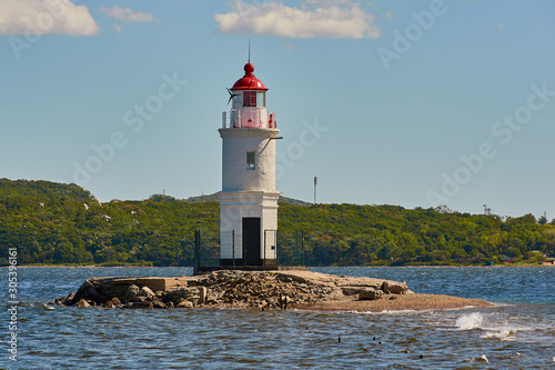 Tokarev lighthouse in Vladivostok washed by the autumn sea of Japan