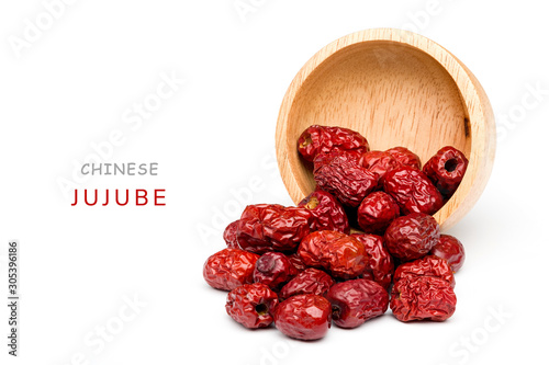 Billede på lærred Bright red Chinese jujube was poured out of a wooden cup spread on a white background