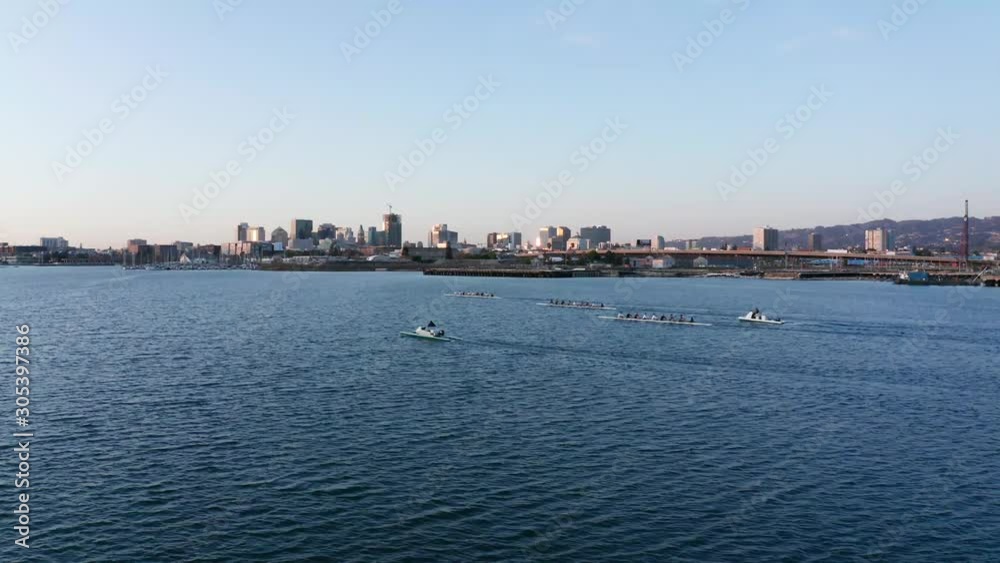 Long shadows and glitter of light across the city and the bay waters. Long shadows and glitter of light across the city and the bay waters.