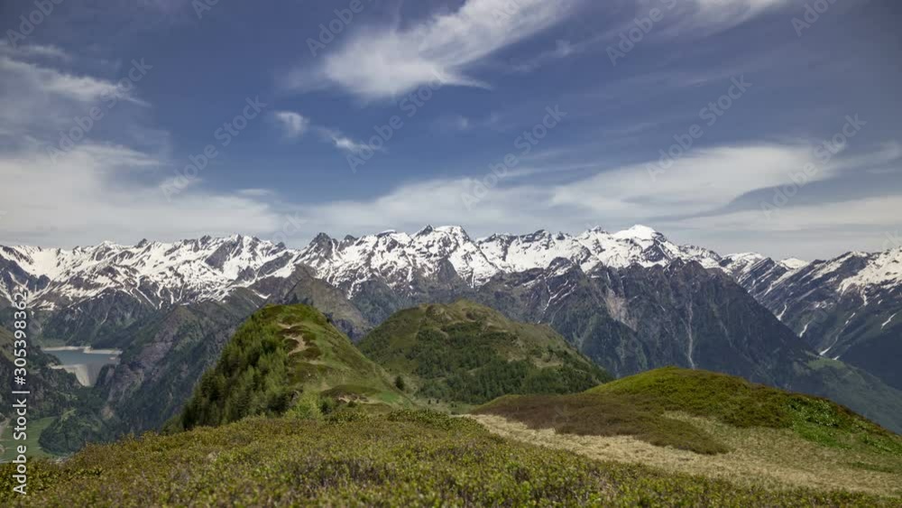 Time lapse panoramic view of the snow-capped peaks of the Alps in the upper Blenio valley in Switzerland, in spring. Time lapse panoramic view of the snow-capped peaks of the Alps in the upper Blenio valley in Switzerland, in spring.