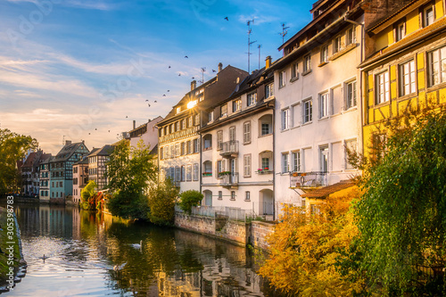 Scenic and iconic cityscape of historic Petite France disctrict, downtown Strasbourg, on a sunny late afternoon. Houses along the Ill river. photo