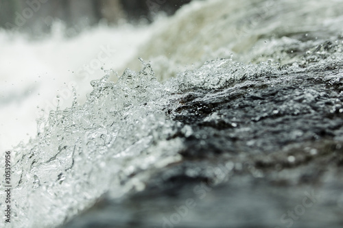 Bubbling water in a waterfall  splashes. Close-up. Abstract picture. North of Russia.