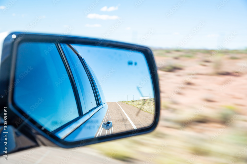 Driving on a highway in the US desert in a spring day