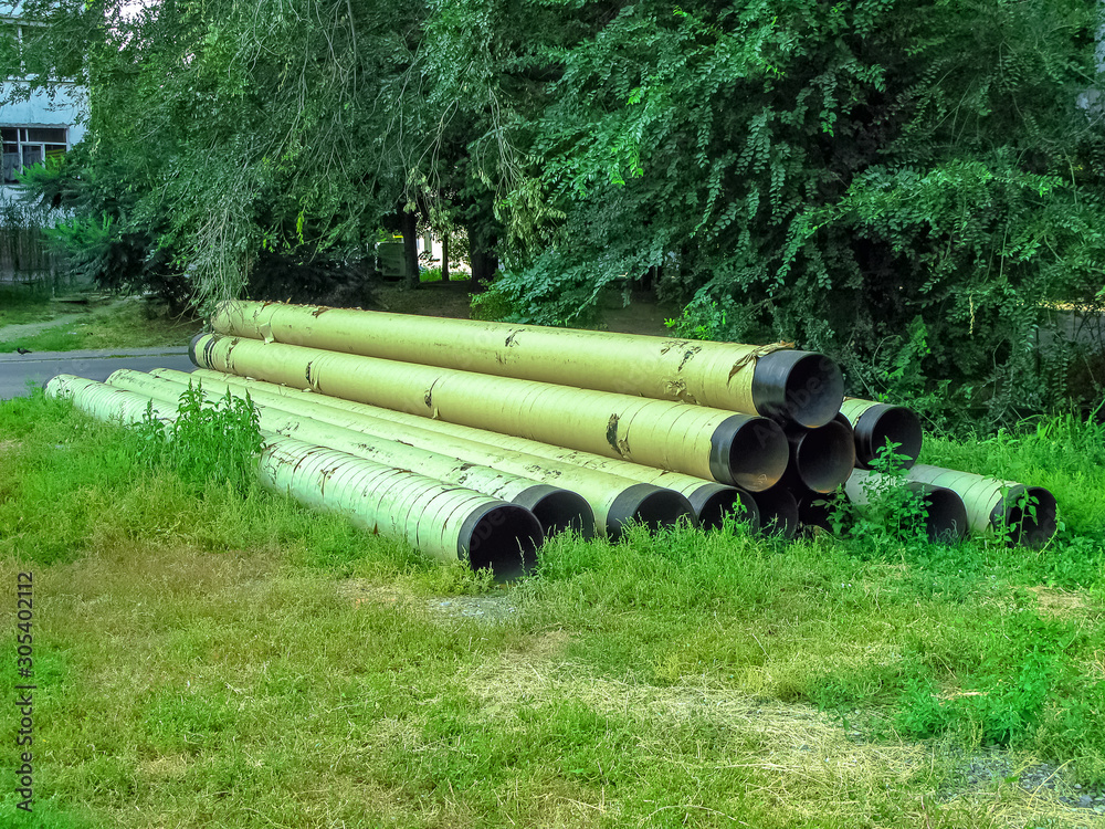 Large water pipes lie on the ground