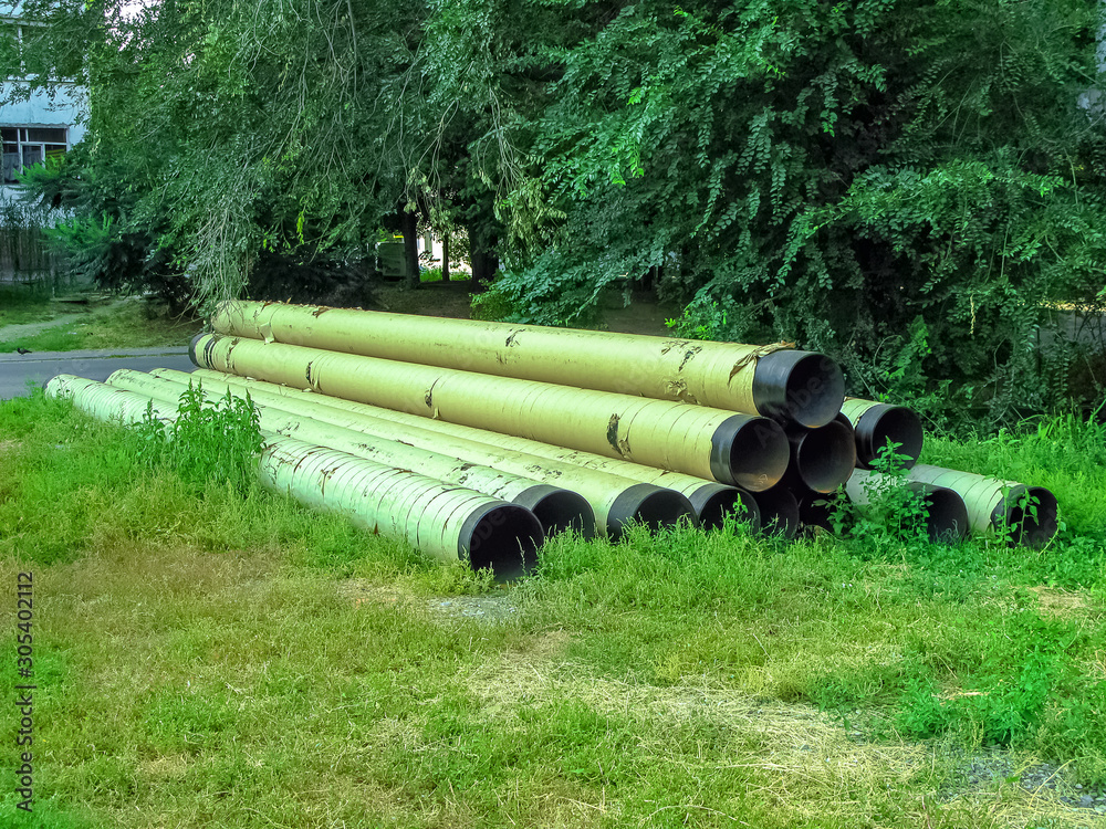Large water pipes lie on the ground Large water pipes lie on the ground