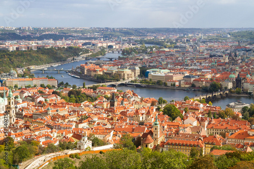 City views Prague autumn. Green foliage in the foreground. Tiled roofs. Petrshin. photo