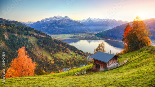 Spectacular autumn view of lake meadows trees and mountains in Sell Am See