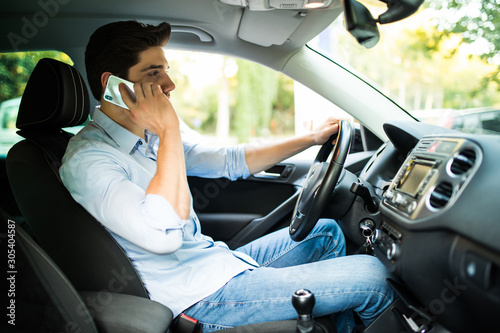 Man talking on the phone while driving car