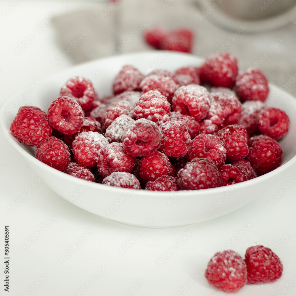 Fresh raspberry in a wooden plate with wooden spoon. Rustic style. Close up. Zero waste concept Fresh raspberry in a wooden plate with wooden spoon. Rustic style. Close up. Zero waste concept