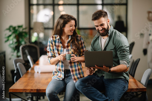 Colleagues in office. Businesswoman and businessman discussing work in office. Two friends in working together.  