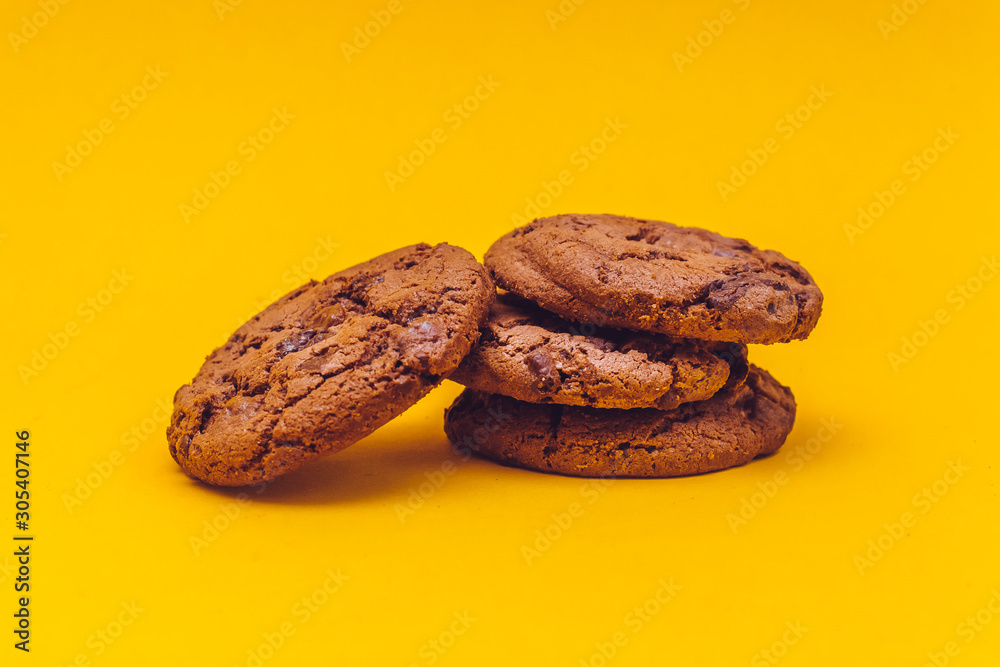 Chocolate cookies with yellow background Chocolate cookies with yellow background