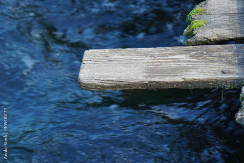 Old gray board on a stream background