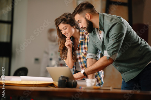 Colleagues in office. Businesswoman and businessman discussing work in office. Two friends in working together. 