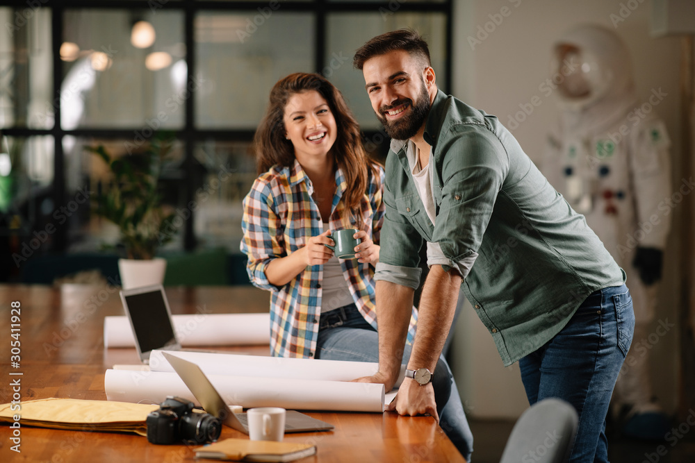 Fototapeta premium Businesswoman and businessman discussing work in office. Two friends in working together. 