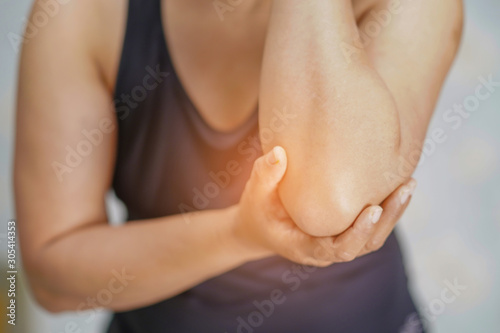Canvas Print Asian middle-aged lady woman patient touch and feel pain her elbow and arm : healthy medical concept