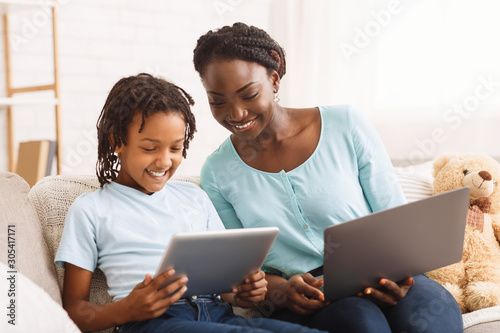 Afro mom and daughter doing school homework