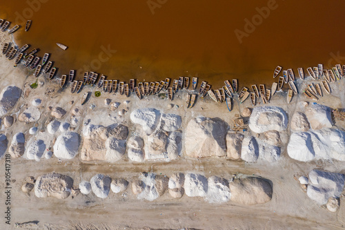 Aerial view of the small boats for salt collecting at pink Lake Retba or Lac Rose in Senegal. Photo made by drone from above. Africa Natural Landscape. photo