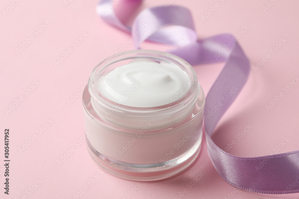 Jar of winter cream for skin on pink background, space for text. Closeup Jar of winter cream for skin on pink background, space for text. Closeup