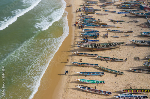 Aerial view of fishing village, pirogues fishing boats in Kayar, Senegal.  Photo made by drone from above. Africa Landscapes. photo