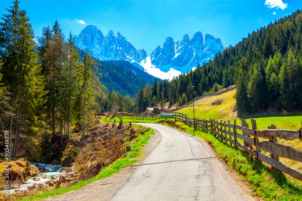 Alpine road with a beautiful view in Santa Maddalena village, Dolomites, Italy.