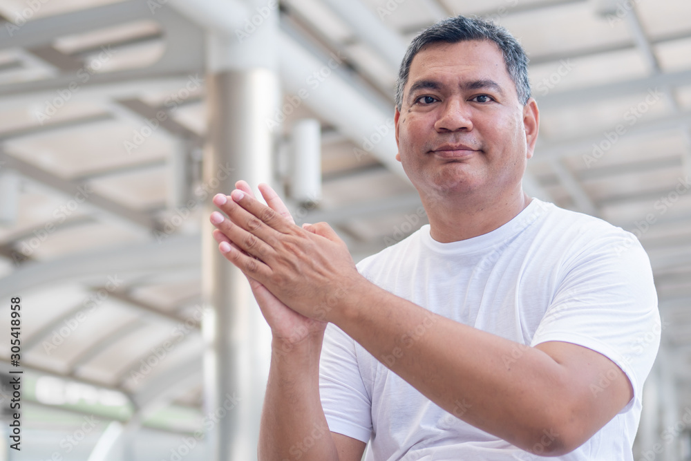 Fototapeta premium confident old senior man clapping his hand; strong happy healthy asian senior man in city environment; senior old man model for senior citizen, pensioner, retired man concept usage