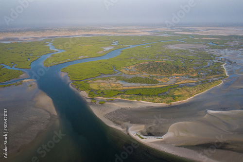 Aerial view of mangrove forest in the  Saloum Delta National Park, Joal Fadiout, Senegal. Photo made by drone from above. Africa Natural Landscape. photo