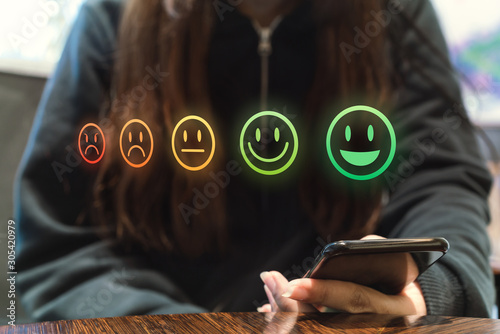 Female client rating customer service experience on business satisfaction feedback survey using smartphone