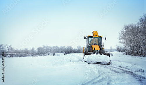 Snow clearing. Tractor clears the way after heavy snowfall.