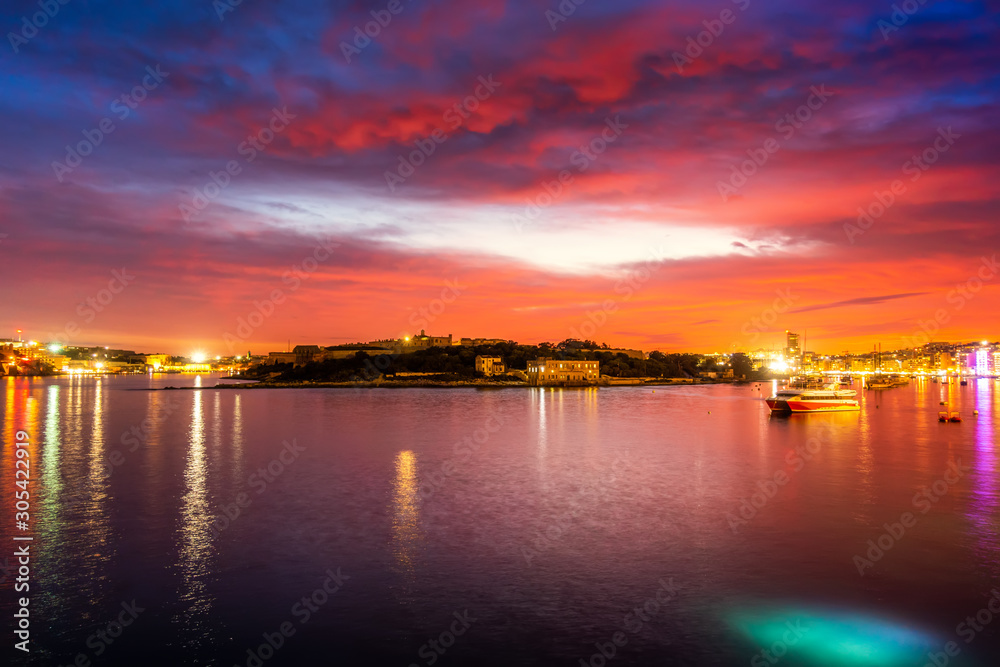 Colorful sunset sky and cloud in twilight time background. Landscape of Sliema, Malta.