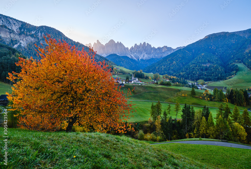 Autumn daybreak Santa Magdalena famous Italy Dolomites village view in front of the Geisler or Odle Dolomites mountain rocks. Picturesque traveling and countryside beauty concept background.