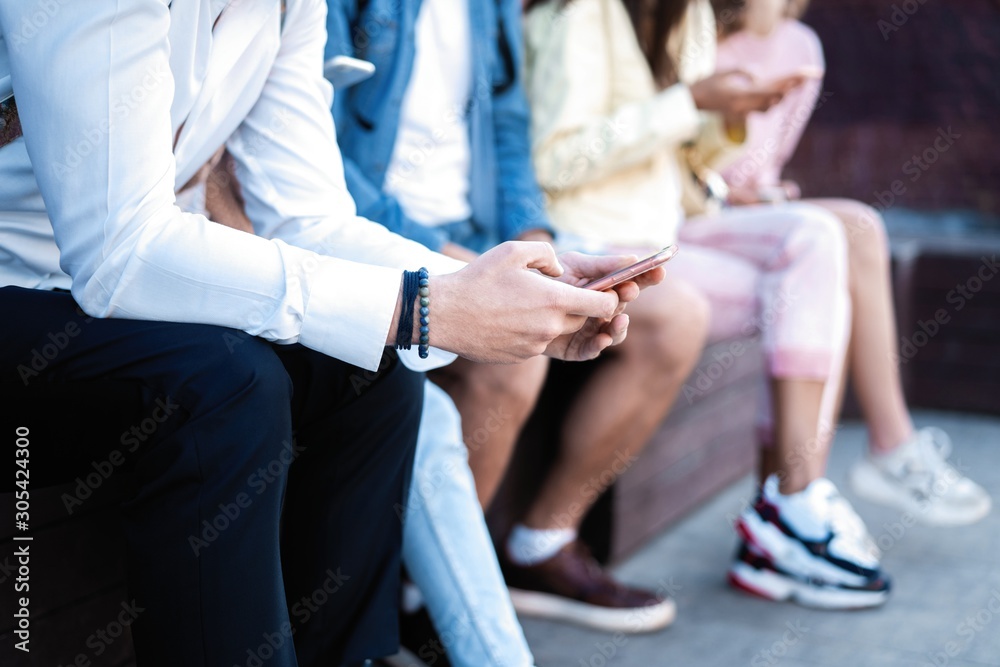 Obraz premium People sitting with smartphones, reading messages, posts in social networks.