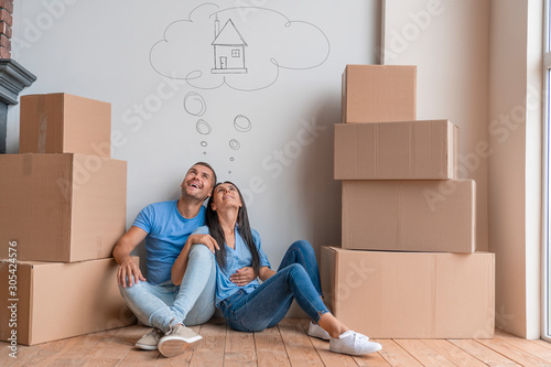 Young couple with dreaming about moving into new house photo