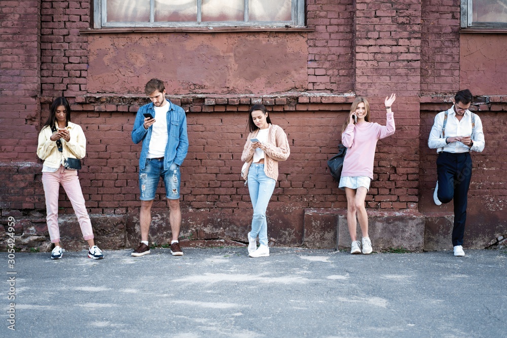 Fototapeta premium People standing with smartphones, reading messages, posts in social networks.