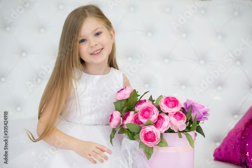 Beautiful child girl with flowers.