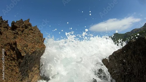 breaking waveson a beautiful day in Mallorca WITH water splashes on the camera SLOW MOTION photo