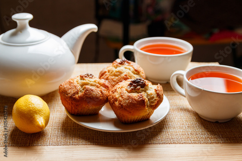 ready breakfast with muffins and lemon tea for two