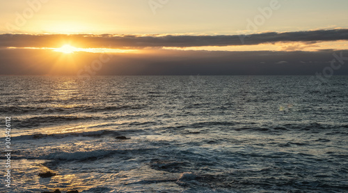 Sun shining over the sea at sunset