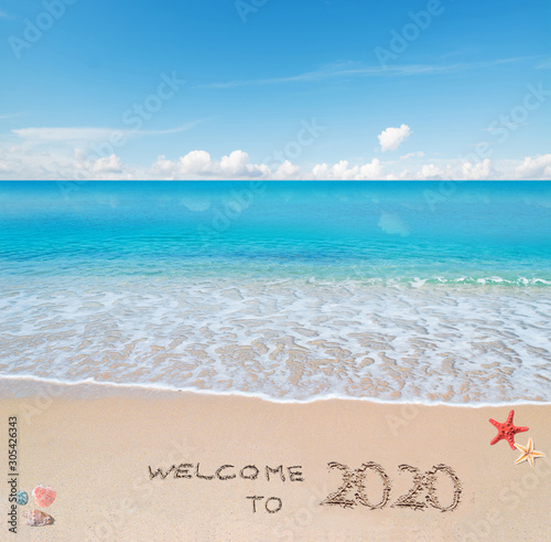 welcome to 2020 written on the sand