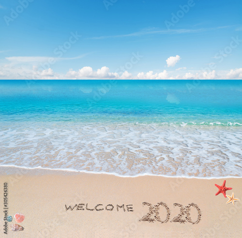 welcome 2020 written on the sand