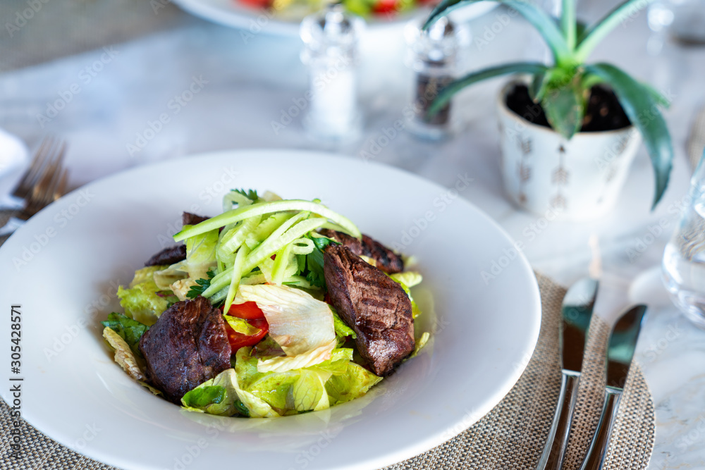 A delicious beef salad is served in a elegance restaurant or hotel