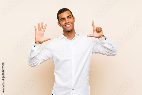 Young handsome brunette man over isolated background counting seven with fingers