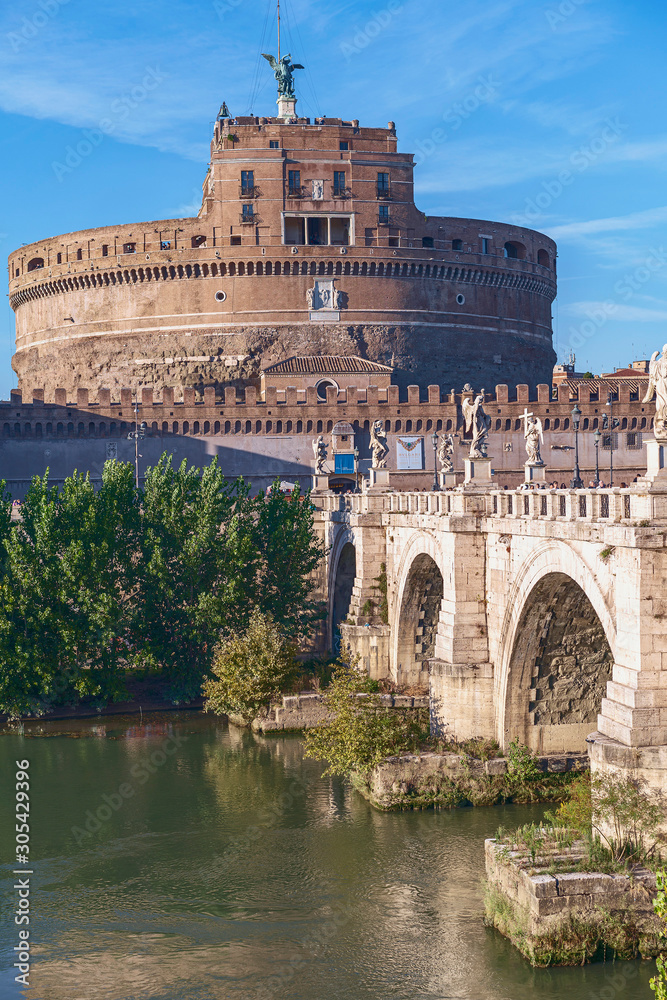 view of the bridge and the castle of the holy angel against the background of the river and blue sky