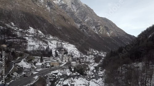 Cinematic aerial view at Lavertezzo, Switzerland in winter season. Lavertezzo is a small village with a valley and mountains along the river Verzasca in the Swiss canton Ticino.
