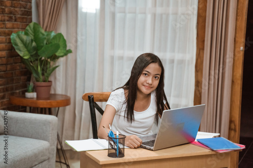 Tablou pe pânză portrait of young teenager junior high school student studying at home