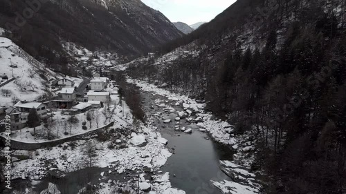 Cinematic aerial view at Lavertezzo, Switzerland in winter season. Lavertezzo is a small village with a valley and mountains along the river Verzasca in the Swiss canton Ticino.