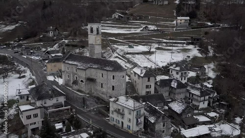 Cinematic aerial view at Lavertezzo, Switzerland in winter season. Lavertezzo is a small village with a valley and mountains along the river Verzasca in the Swiss canton Ticino.