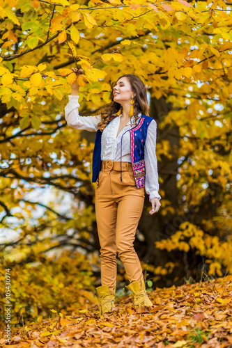 Fototapeta Naklejka Na Ścianę i Meble -  Portrait of a beautiful woman in autumn landscape