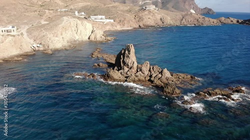 The stunning natural park of Cabo de gata in Spain, with clear water and ragged cliff formations. photo